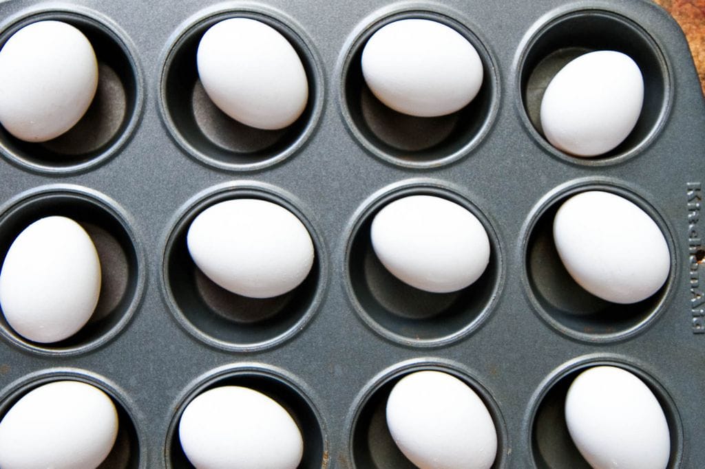 Hard Boiled Eggs In The Oven Recipe Placed in Muffin Tin